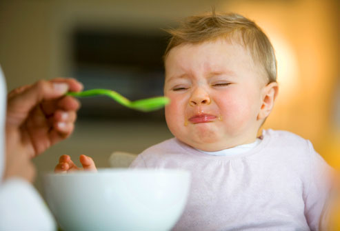 Unhappy baby eating